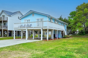 A large, two-story house with a covered porch and multiple windows.