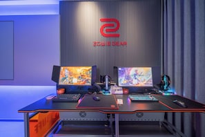 A gaming setup with two monitors, a keyboard, a mouse, and a headset. - BUFF Esports Hotel Zhuhai Xiangzhou  (Zhuhai)