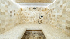A spa room with mosaic tiled walls and floor, a bench, and a showerhead. - 008 Villa Rosoliel in Cannes (Cannes)
