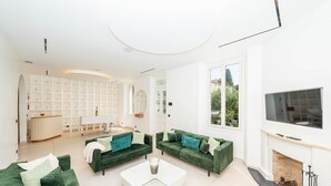 A modern living room with green sofas, a white coffee table, and a fireplace. - 008 Villa Rosoliel in Cannes (Cannes)
