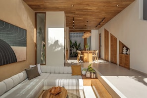 Un interior moderno con un sofá blanco, techo de madera y una zona de comedor con mesa y sillas.