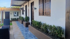 A covered outdoor area with a pathway, seating, and planters. - Room-1 Person in 6 bed Dorm Mixed (Puerto Galera)