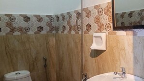 A bathroom with a toilet, sink, shower, and a mirror. - Room-1 Person in 6 bed Mixed Dormitory (Puerto Galera)