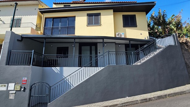 A multi-story building with balconies, a staircase, and a flat entrance area. - Charming 1-bedroom Apartment With Ocean Views in Calheta (Calheta)