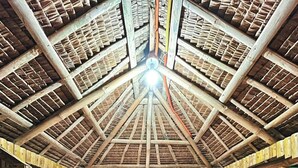 A wooden hut with a thatched roof, multiple benches, and a central table. - Soulelle Villa (Silang)