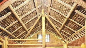 A rustic wooden cabin with a loft bed, a ladder, and a window. - Soulelle Villa (Silang)