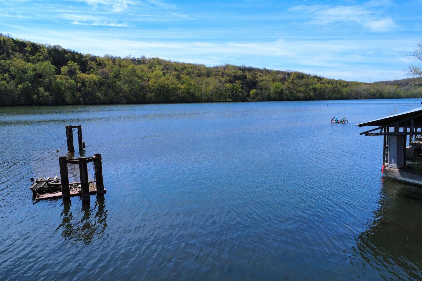 A calm lake with a dock and a wooden pier extending into the water.