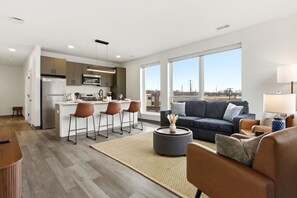 A modern apartment with a kitchen, dining area, and living room. - Relaxing & Central Two Bedroom Two Bathroom (Cleveland)
