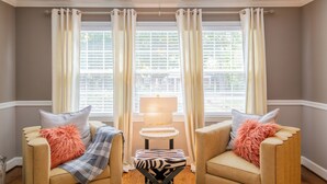 A room with two armchairs, a small table, and a lamp. - Spacious 6BR w/ Firepit, Porch, Prime Location (High Point)