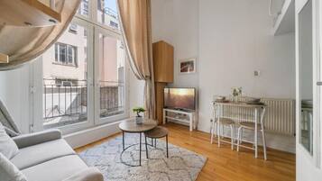 Deluxe Apartment, Balcony | Living area | Flat-screen TV
