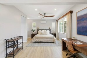 A bedroom with a bed, desk, and a ceiling fan. - Hillside 2-Story | Dual Living | Mountain View (Vista)