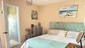 A bedroom with a bed, bedside table, dresser, and a door leading to a balcony. - 3-bedroom houseone of the safest areas in Long Beach - Bixby centrally located (Long Beach)