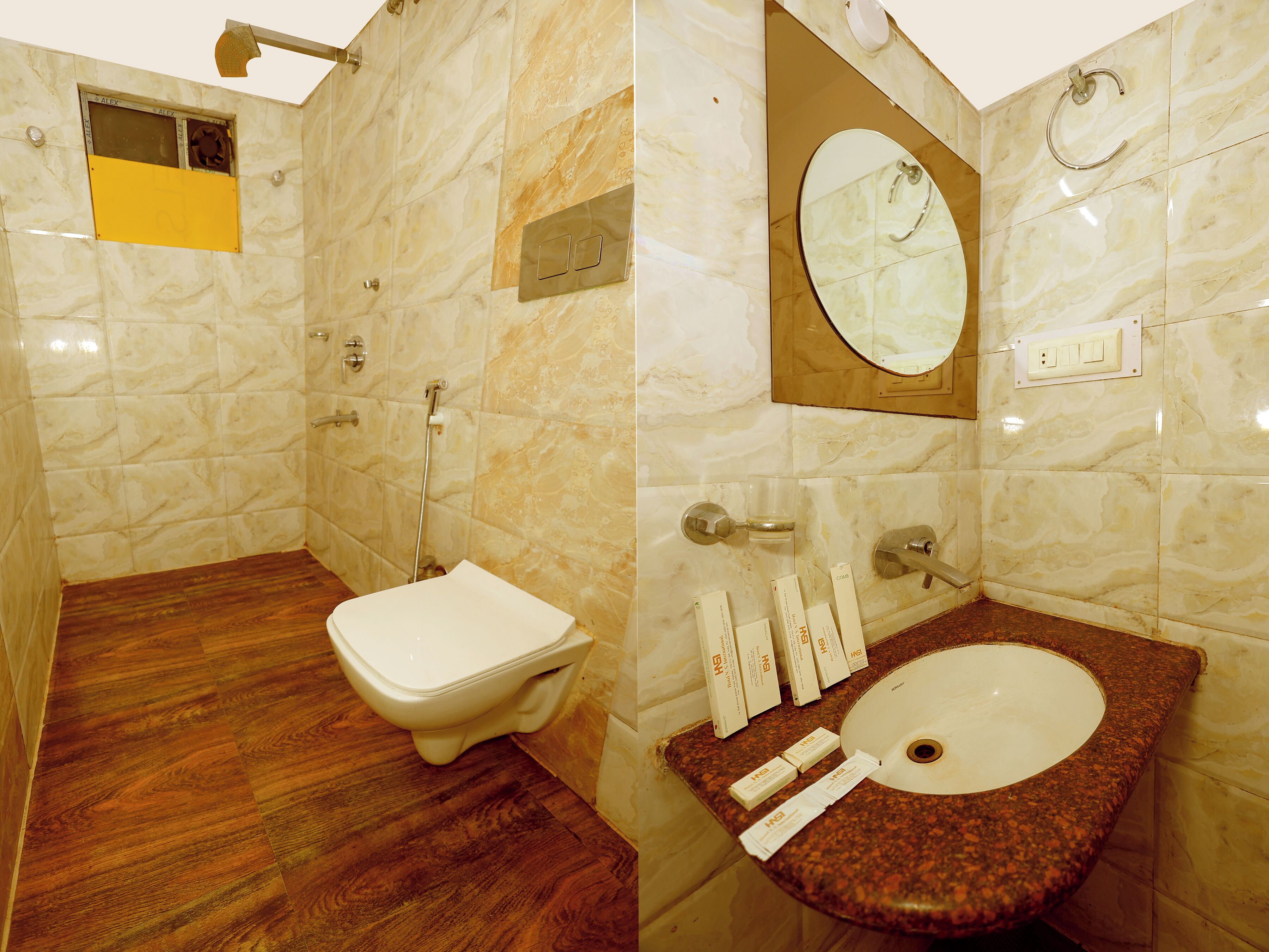 A bathroom with a toilet, shower, and sink.