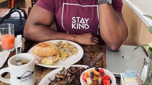 A person sitting at a table with a meal consisting of eggs, steak, and a fruit bowl. - Top Rated w/Free Street Parking+ 2 King Beds 1 Single +In Unit-Laundry +1.5 Bath (Chicago)