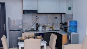 Eine moderne Küche mit Kühlschrank, Herd und Wasserspender.