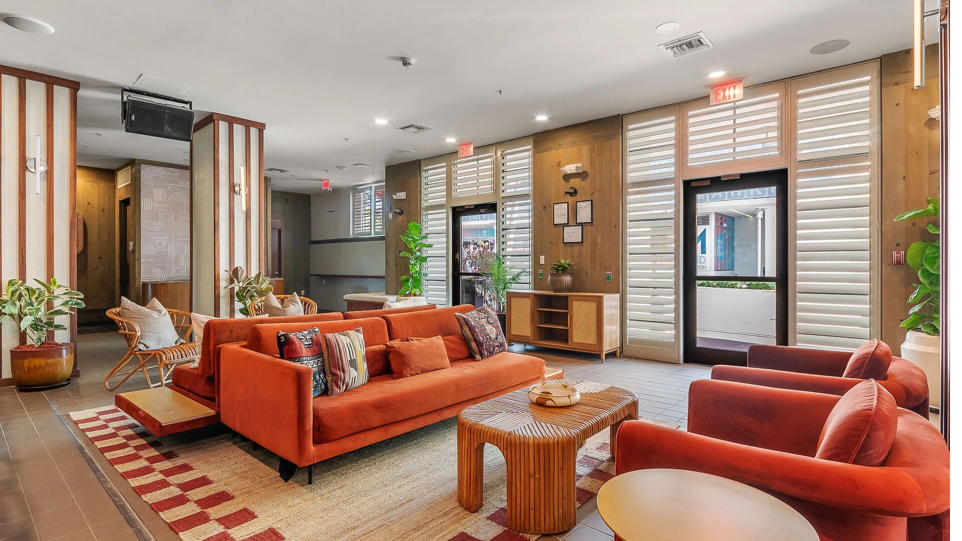 A modern hotel lobby with a sofa set, a coffee table, and a seating area.