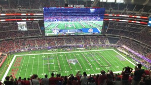 A football stadium with a large screen displaying a marching band performance. - Serene 3-bedroom house with AC, on-site laundry in welcoming Arlington (Arlington)
