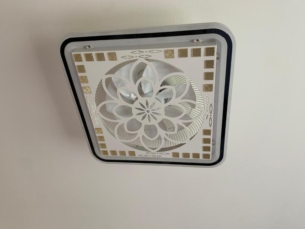 Un soffitto con un pannello decorativo caratterizzato da un motivo geometrico.