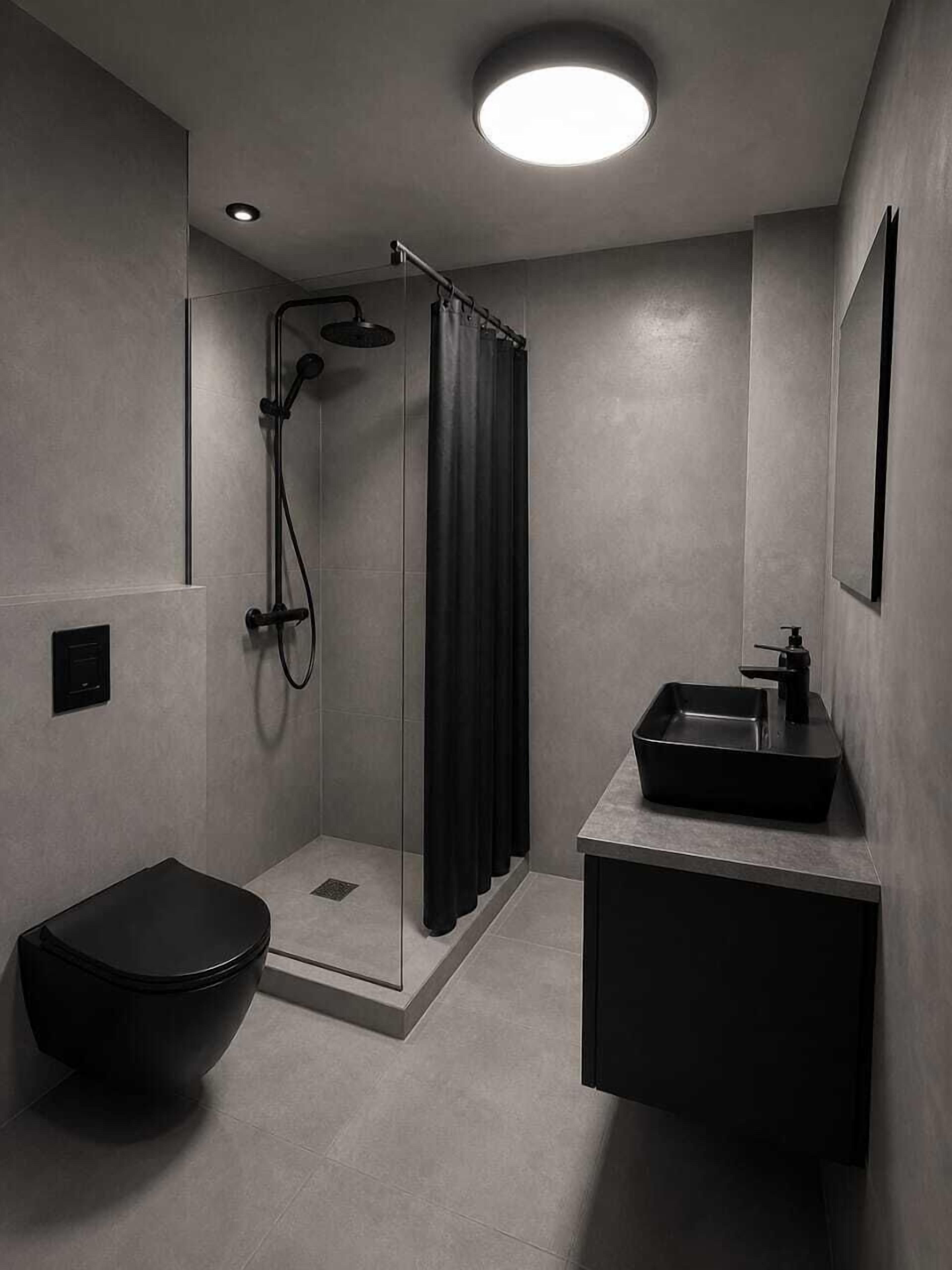 A modern bathroom with a glass-enclosed shower, a black toilet, and a minimalist sink.