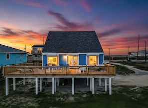 A beachfront house with a deck, multiple rooms, and a view of the ocean. - Hit the Beach (Galveston)