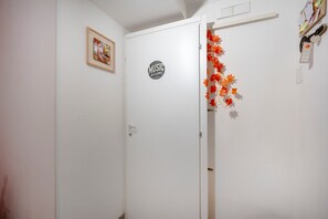 A white door with a 'MUSIC ROOM' sign, a framed picture on the wall, and autumn leaves decoration. - Apartment 'Kaktus 2 - Music' with Wi-Fi and Air Conditioning (Bari)