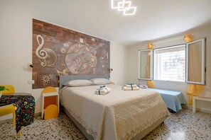 A bedroom with a bed, a desk, a chair, a window, and a wall mural. - Apartment 'Kaktus 2 - Music' with Wi-Fi and Air Conditioning (Bari)