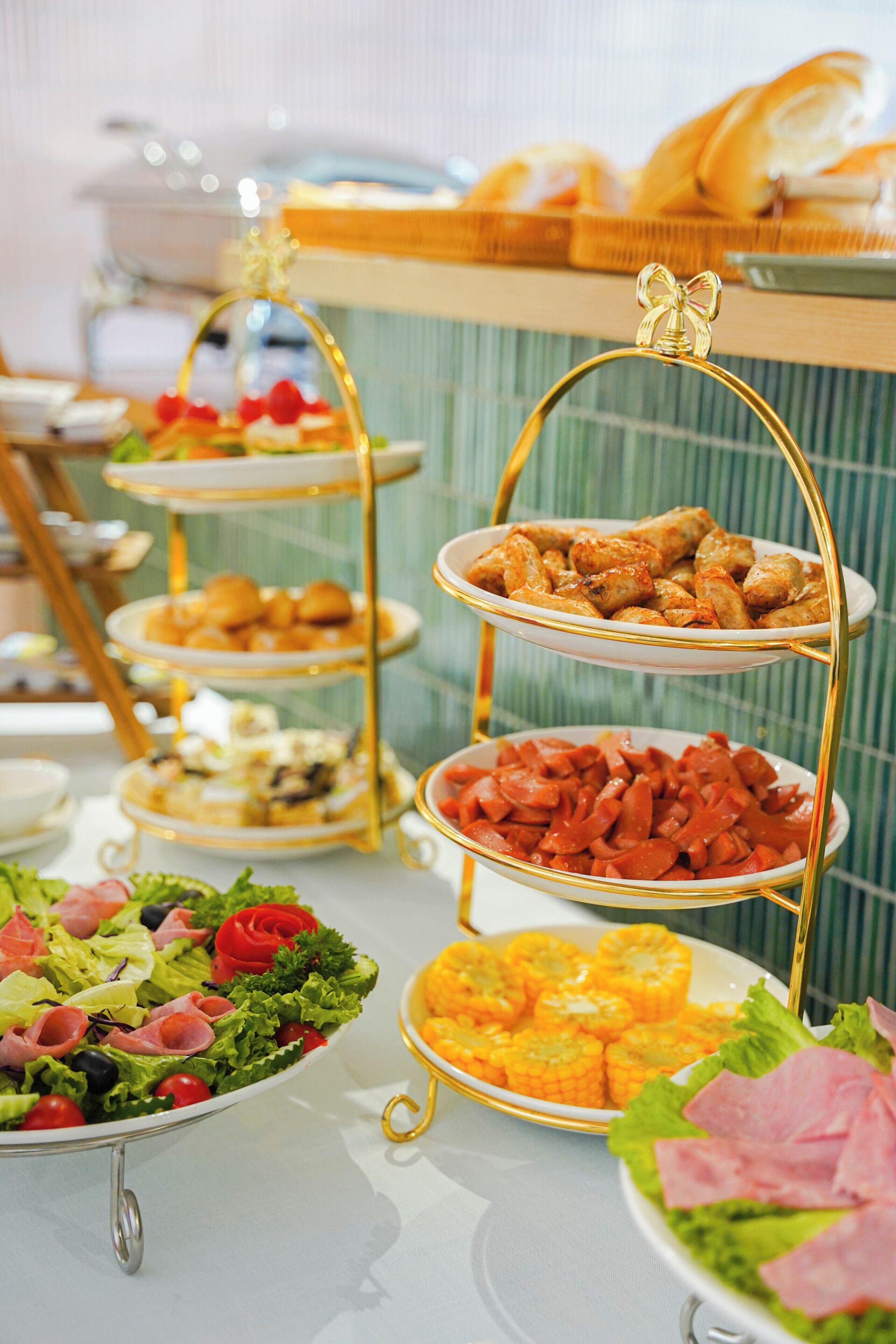 A buffet with multiple serving platters, including salads, meats, and appetizers.