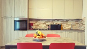 A modern kitchen with a built-in oven, microwave, and coffee maker. - Large apartment with lake view terrace 5 minutes walk from the center (Bardolino)