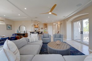 A spacious living room with a large sofa, two armchairs, a coffee table, and a ceiling fan. - South Mission Sand & Surf Retreat with AC & 3 Car Garage! (San Diego)