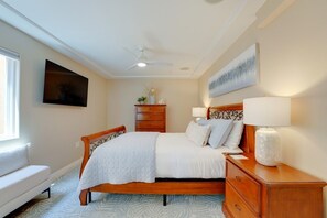 A bedroom with a bed, bedside tables, a dresser, a ceiling fan, a flat-screen TV, and a window. - South Mission Sand & Surf Retreat with AC & 3 Car Garage! (San Diego)