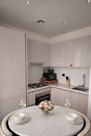 Fridge, microwave, stovetop, coffee/tea maker