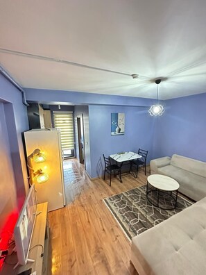 Family Apartment | Living area | 42-inch Smart TV with satellite channels