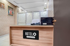 A hotel reception desk with a sign indicating it is company-serviced. - Classic Rainbow Gold Inn (Lucknow)