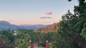 A gated entrance with a view of mountains and greenery. - Peaceful Gated Home, Fast Wifi for Remote Work, Private Pool, BBQ, Kids Area (Casabermeja)