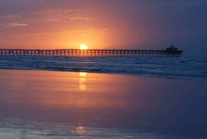A pier extending into the water with a sunset in the background. - Sunset Serenity marsh view w/pool (North Myrtle Beach)