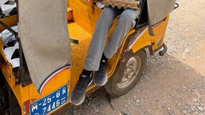 A yellow auto-rickshaw with a covered canopy, a passenger, and a child. - Cozy 1-bedroom apartment in perfect Greater Accra with AC, Fibre Internet (Greater Accra)
