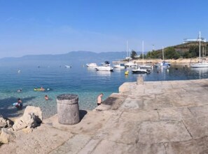 A coastal marina with boats, clear water, and a stone walkway. - Comfort Kostrena Apartments Rijeka (Kostrena)