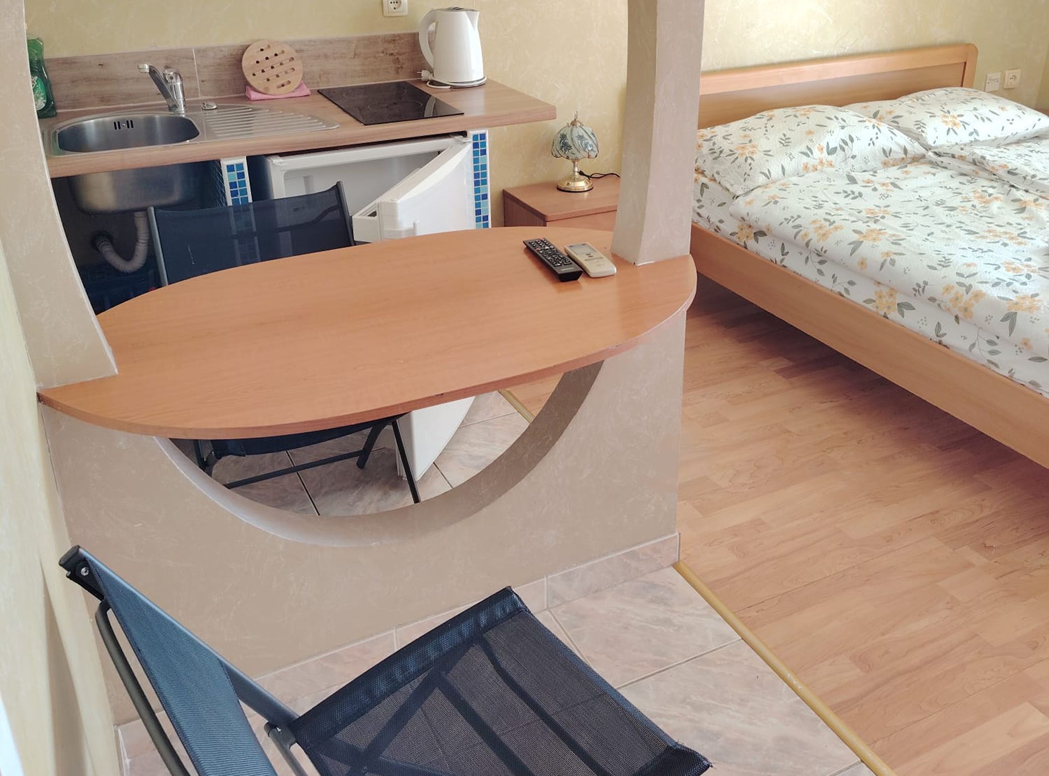 A compact room with a bed, a desk, and a chair.