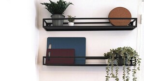 Une cuisine équipée d’un four à micro-ondes, d’une machine à café et d’une étagère avec des plantes.