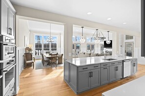 Kitchen - The kitchen island with seating faces the lake side of the home, with the great room fireplace just around the corner. - Fairview Lake Haven | New Waterfront Home | Private Side | 6BR/4BA | Boathouse & Dock (Mineral)