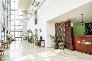 A spacious lobby with high ceilings, large windows, and a reception desk. - Moonlight Suite · Balcony · Tulum (Tulum)