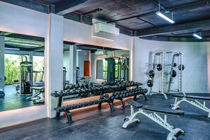 A gym with weight benches, dumbbells, and exercise equipment. - 1BR + Private Pool · Jungle View · Beach Shuttle (Tulum)