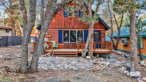 A rustic cabin with a porch, surrounded by trees. - Oakwood Cottage #2582 (Sugarloaf)
