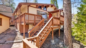 A wooden cabin with a deck, a staircase, and a chimney. - 2655 - Highland Hideout (Big Bear Lake)