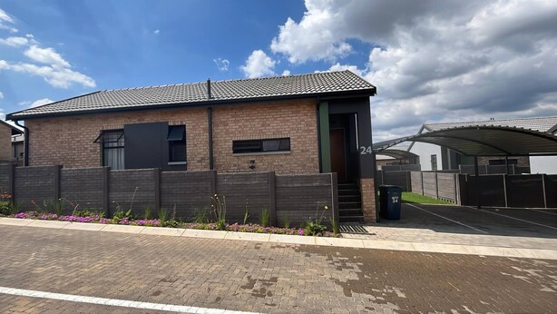 A brick building with a tiled roof, a gated entrance, and a paved driveway. - Charming 3-bedroom House Rental in Centurion, South Africa (Centurion)