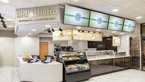 A Starbucks coffee shop with a counter, menu boards, and a display case. - Orlando Studio Villa Near Disney - Westgate Lakes (Orlando)