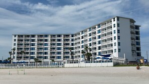 A multi-story hotel with balconies, located near a beach. - Oceanfront Balcony - Pool - Islander Beach Resort, New Smyrna Beach! (New Smyrna Beach)