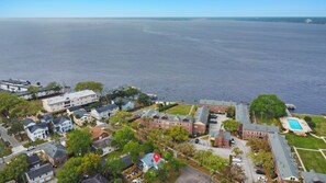 An aerial view of a coastal residential area with houses, a swimming pool, and a marina. - NEW! The River Palm-Downtown San Marco/JAX -Spa-Firepit- Pet Friendly (Jacksonville)