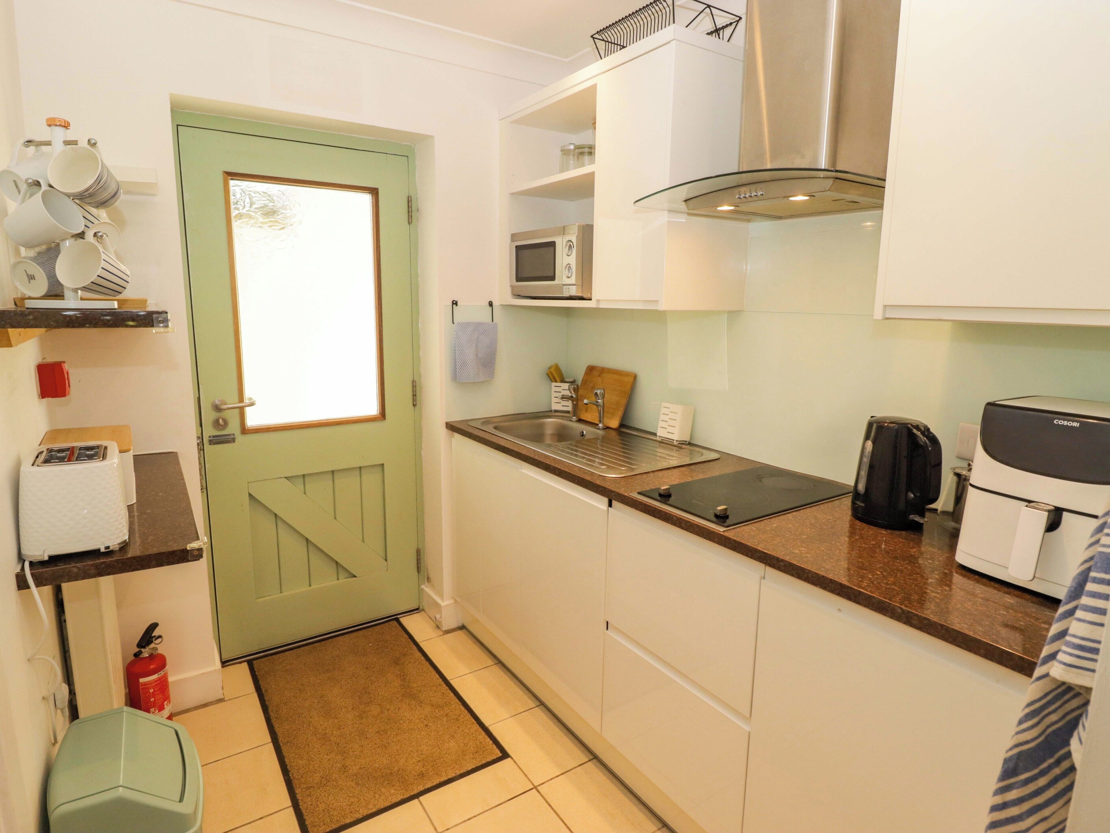 A compact kitchen with a microwave, toaster, and coffee maker.