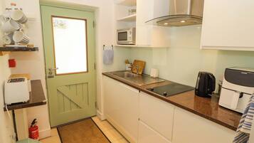A compact kitchen with a microwave, toaster, and coffee maker.